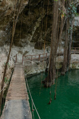 Mayan cenote with crystal clear waters in the archeological zone of ek balam in yucatan mexico
