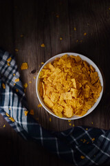 Corn Chips. Chips in white bowl on natural wooden table. in dark and texture background. good for snack time