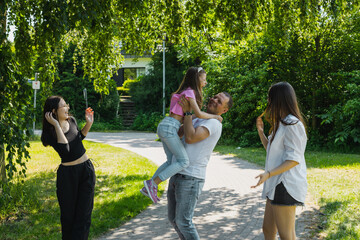 Portrait of a young couple on a bridge in the park.