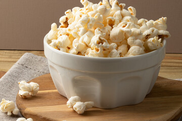 Salty popcorn in a white bowl.