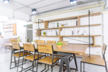 Blurred background cafe coffee shop restaurant in shopping mall with light bokeh business event retail store. Blurry background interior design bar table chair windows decorate indoor space display