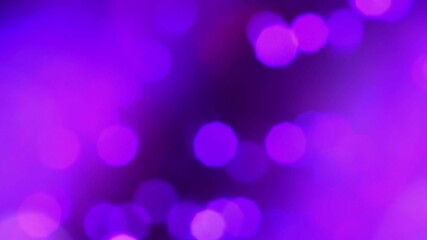 Defocused fluorescent pink purple color bokeh on dark black abstract background. Bokeh radiance reflection
