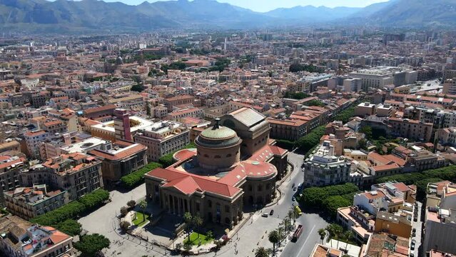 Aerial shot drone hovers over Teatro Massimo with birds flying around in Palermo, Sicily, Italy