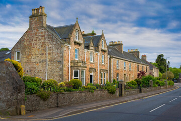 Fototapeta na wymiar 2023-06-02 A SINGLE ROW OF HOMES SHOWING THE LOCAL ARCHITECHURE IN INVERNESS SCOTLAND WITH A NICE SKY
