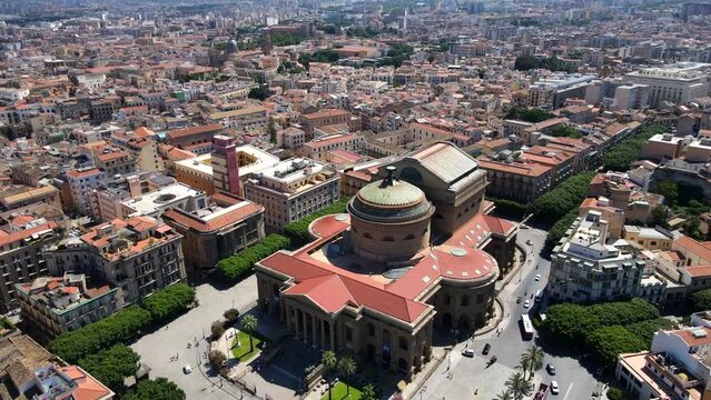 Aerial shot drone flies forward as camera pans down over Teatro Massimo in Palermo, Sicily, Italy