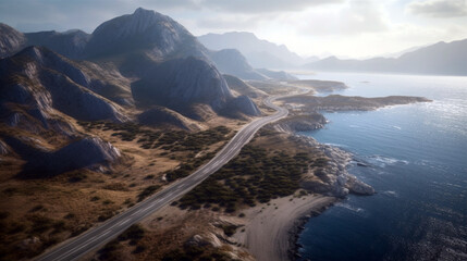 Aerial view of a road following the coastline with mountain range in background