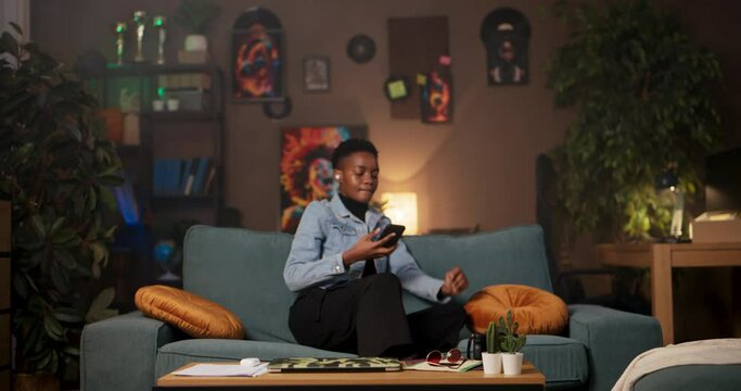 African woman talks on cellphone while wearing headphones language interpreter providing interpretation services for clients or facilitating communication individuals speaking different languages.
