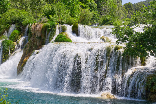 Beautiful Waterfall background in sunny summer day. Beautiful Waterfall In Krka National Park - Croatia, Europe. Krka river waterfalls in the Krka National Park © Ilja