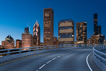 Empty urban asphalt road exterior with city buildings background. New modern highway concrete construction. Concept of way to success. Transportation logistic industry fast delivery. Chicago. USA.