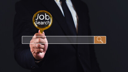Businessman using magnifying glass for search jobs against dark background with empty space.