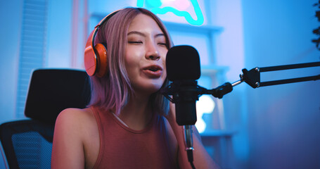 Asian young Esport woman gamer feel good when winning play online game on PC