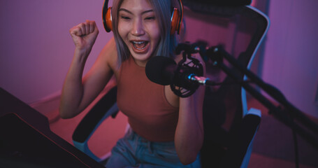 Fototapeta na wymiar Asian young Esport woman gamer enjoy to play online game on PC