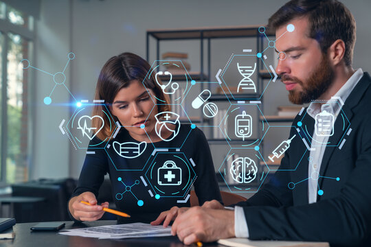 Businesspeople in formal wear taking notes signing contract at office workplace. Concept of important working moments, document sign, working process, concentration. Medical icons hologram