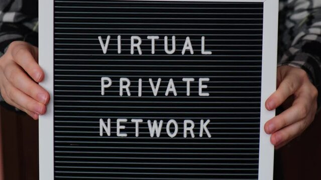 Female hand holding Letter board with text of VIRTUAL PRIVATE NETWORK VPN creation Internet protocols for protection private network anonymous safe and secure internet access on gadgets. Future