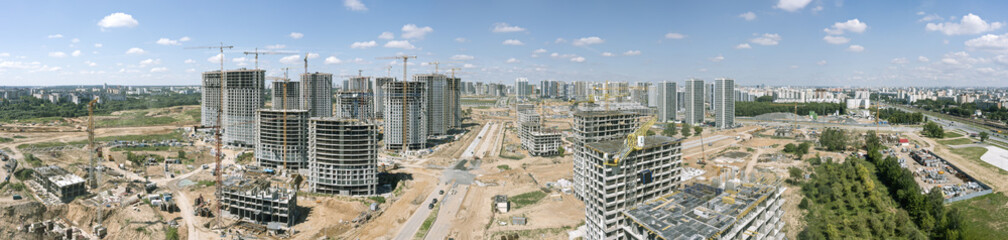 super wide aerial panorama of construction site in urban development of real estate investment project in new neighborhood.