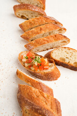 freshly baked baguette slices with tomato suace on top view with white background