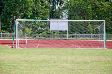 The soccer goal has a net on the field.