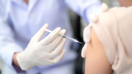 Close up of doctor making a vaccination in the shoulder of patient, Flu Vaccination Injection on...