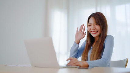 Young asian woman working on computer laptop at house. Work at home, Video conference, Video call, Student learning online class, meeting conference