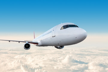 Modern white passenger airplane flying in the sky