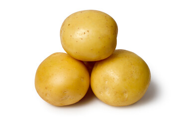Natural organic potatoes on a white background. Whole raw potato tubers close-up.