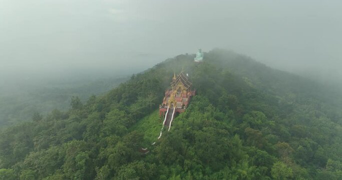 Aerial View at Morning Wat Phra That Doi Phra Chan. and Daibutsu Buddha on the mountain at Lampang Province Thailand 4k video from Drone.