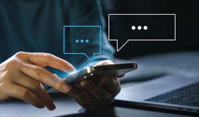 Human hand using smartphone typing Live chat chatting and social network concepts, chatting conversation working at home in chat box icons pop up. Social media marketing technology concept