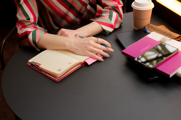 Woman writing in notebook at the table