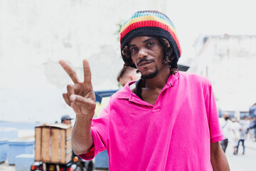 African American man with dreadlocks and a purple T-shirt in Latin America, rastafarian or rastaman...