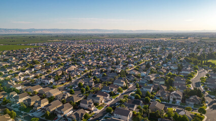 Breathtaking drone photos capture the stunning landscapes of Manteca, California, showcasing its charming houses nestled amidst picturesque surroundings.