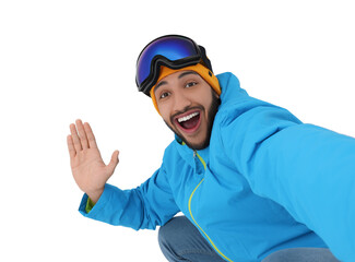 Smiling young man with ski goggles taking selfie on white background