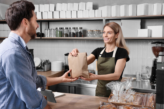 Man buying fresh pastries in bakery shop