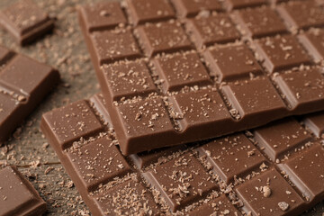 Tasty chocolate bars on wooden table, closeup