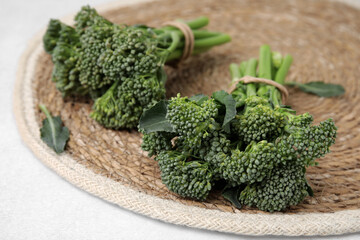 Fresh raw broccolini on white table, closeup. Healthy food