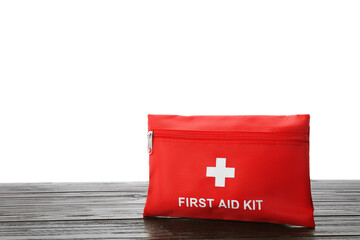 First aid kit on wooden table against white background