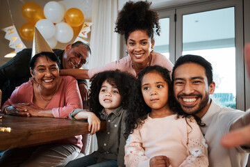 Selfie of grandparents, parents and children at birthday in living room for party, celebration and social event. Family, love and portrait of mom, dad and kids in home with hats, balloon and smile