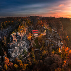 Hrensko, Czech Republic - Aerial panoramic view of the Pravcicka Brana (Pravcicka Gate) in Bohemian Switzerland National Park, the biggest natural arch in Europe with a warm colorful sunrise at autumn