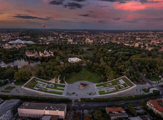 Budapest, Hungary - Aerial panoramic view of the Museum of Ethnography at City Park with House of Music, Vajdahunyad Castle, hot-air balloon, Szechenyi Bath, Biodome and a spectacular sunset sky