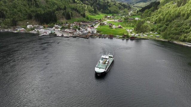 A stunning aerial of a Norway ferryboat left countryside remote village of Eidsdal close to Geiranger in Western Norway