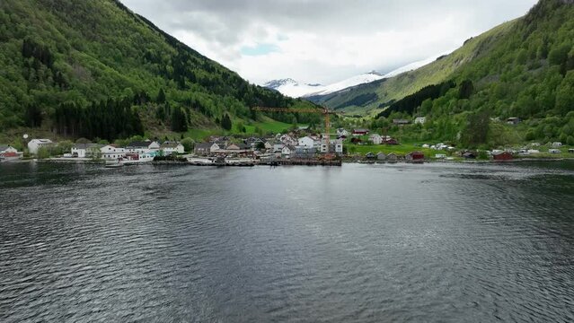 Arriving Eidsdal underway to Geiranger Norway - Fast forward moving aerial close to fjord surface