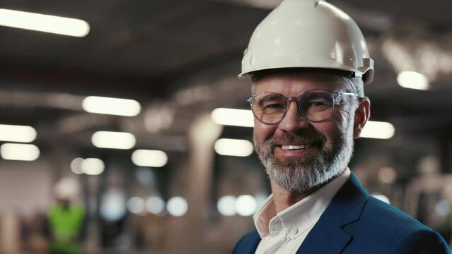 Close Up Portrait of Positive Businessman Factory Leader in Glasses, Looking at Camera, Wearing Suit, Standing in the Repository Centre. Logistic Business: Shipping and Delivery Service Concept