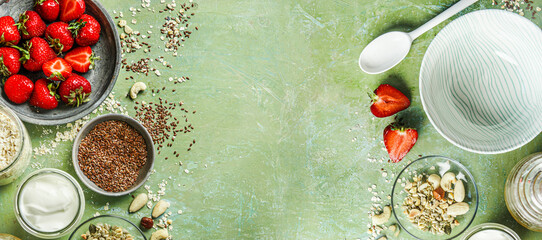 Healthy breakfast background with  oats , strawberries, yogurt, linseed and nuts , top view. Banner