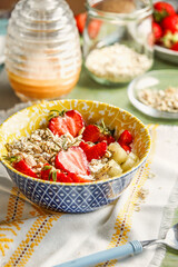 Healthy breakfast bowl with strawberries and oats granola, front view