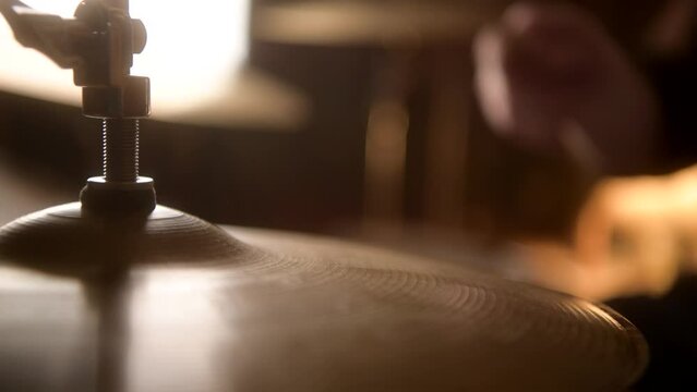 Close up shot of drummer playing on the hi-hat cymbals of the drum kit in a recording studio session