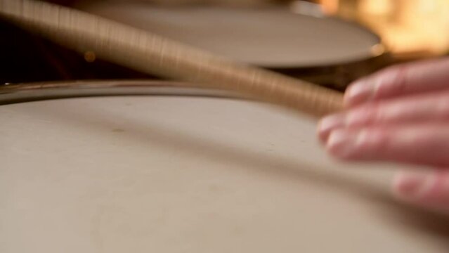 Close up macro shot of snare drum rim hits during a recording session in the studio