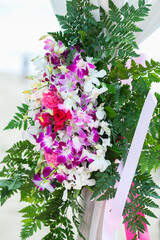 Floral arrangement at a wedding ceremony on beach.