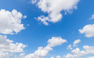 Naklejka na ściany i meble Panoramic view of clear blue sky and clouds, Blue sky background with tiny clouds. White fluffy clouds in the blue sky.