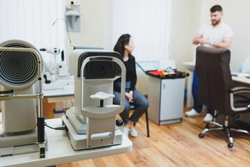 Examination of vision on modern ophthalmological equipment. Eye examination of a woman at an...