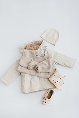Cute hygge pastel clothes and accessories for toddler baby. Warm wearing: sweater, raincoat, rain boots, hat. Aesthetic baby fashion store, shopping concept