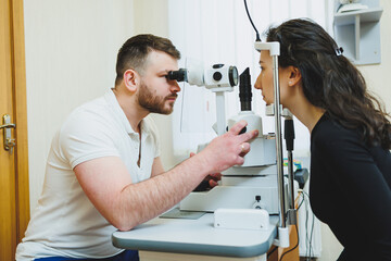 Fototapeta na wymiar Examination of vision on modern ophthalmological equipment. Eye examination of a woman at an ophthalmologist's appointment using microscopes. Vision treatment at an ophthalmologist appointment